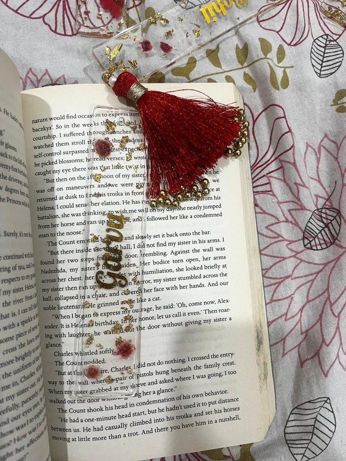 Resin name bookmark with red tassel in book