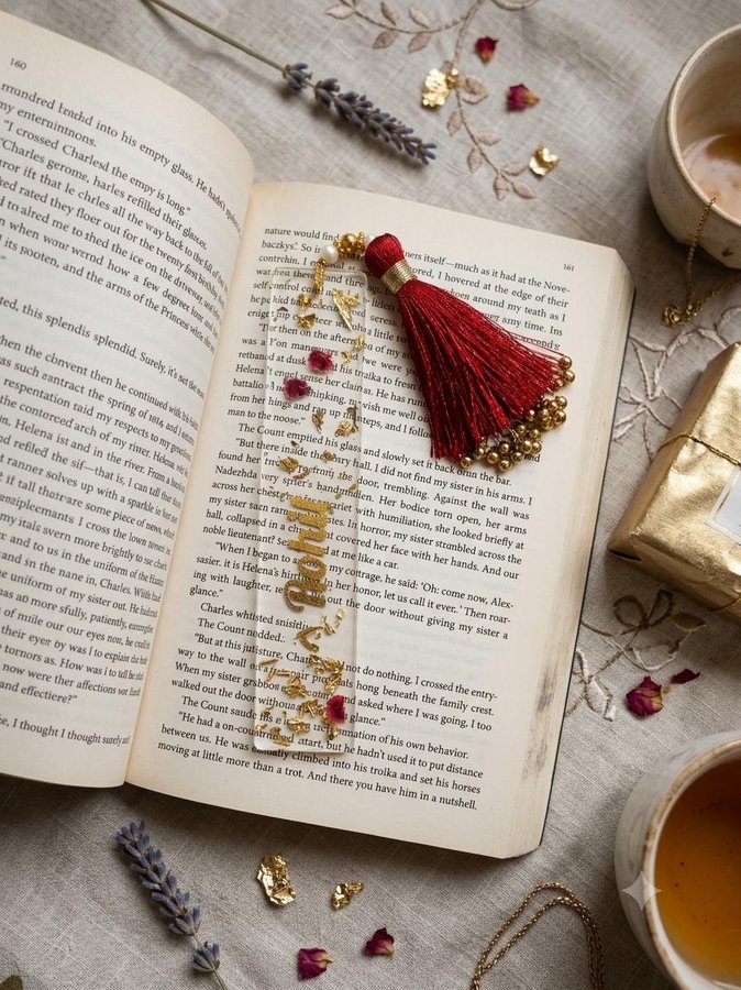 Clear resin floral bookmark flatlay with red tassel