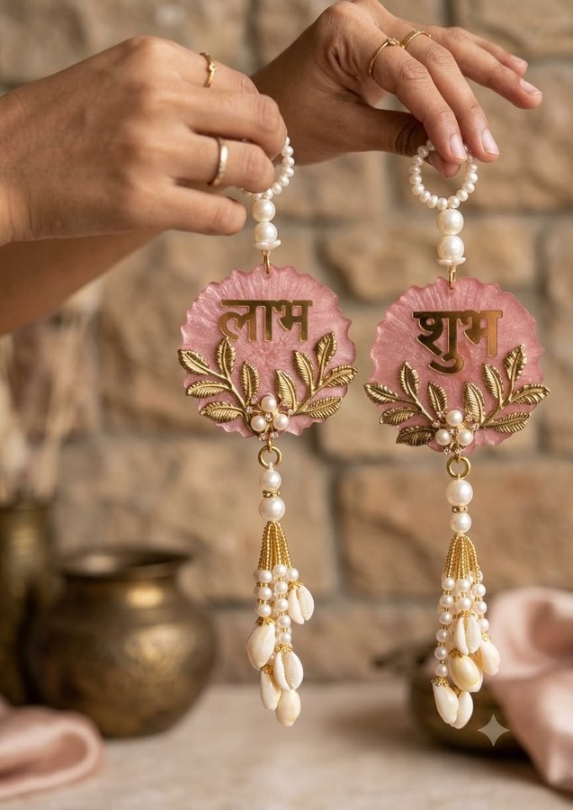 Pink resin Shubh Labh door hangings with cowrie shell tassels